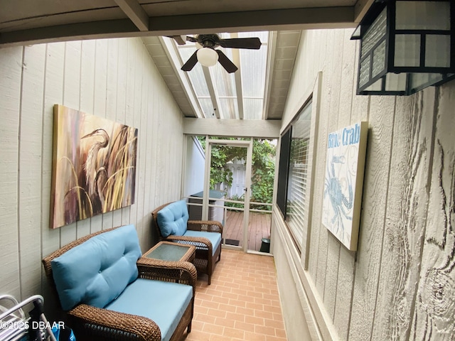 sunroom featuring ceiling fan