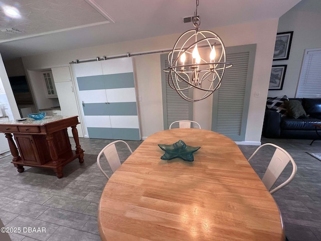 dining room featuring a notable chandelier and a raised ceiling