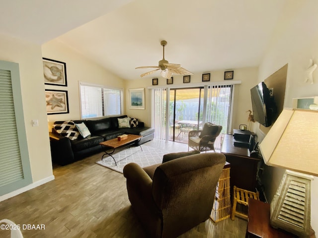 living room with ceiling fan, wood-type flooring, and lofted ceiling