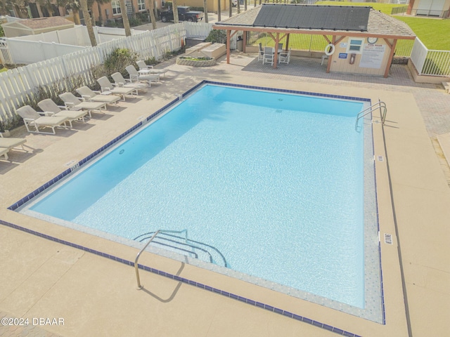 view of swimming pool with a patio and a gazebo