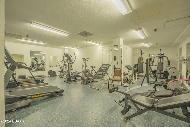 exercise room with a textured ceiling