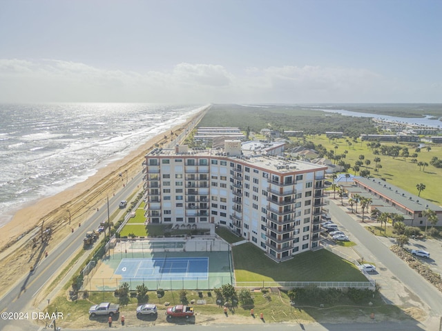 birds eye view of property featuring a beach view and a water view