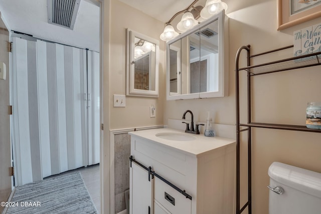 bathroom featuring vanity and toilet