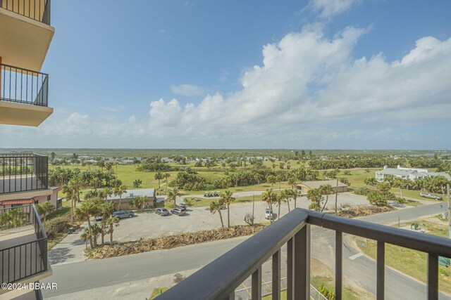 balcony featuring a beach view and a water view