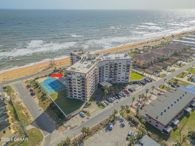 birds eye view of property with a view of the beach and a water view