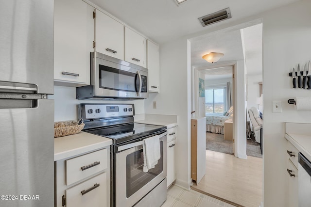 kitchen featuring white cabinetry and appliances with stainless steel finishes