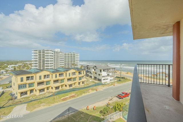 balcony featuring a water view and a view of the beach