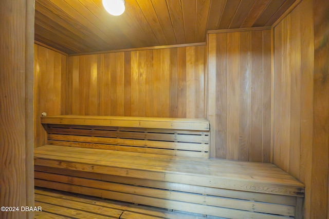 view of sauna featuring wood walls and wooden ceiling