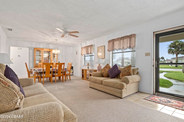 living room with plenty of natural light, light carpet, a textured ceiling, and ceiling fan