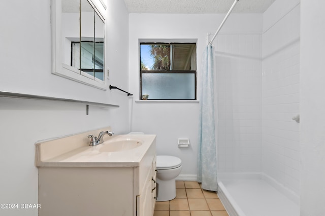 bathroom with tile patterned flooring, a textured ceiling, curtained shower, vanity, and toilet