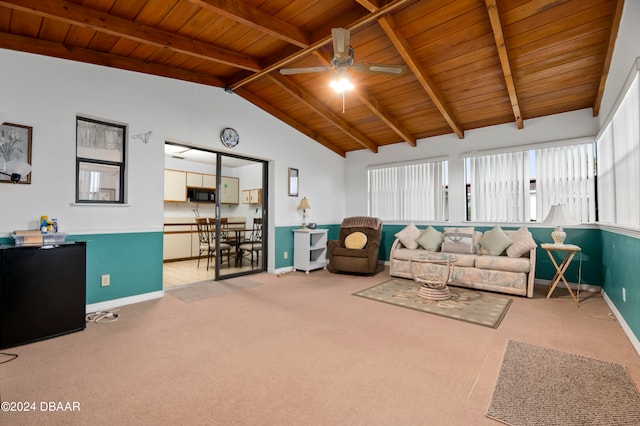 living room featuring lofted ceiling with beams, light colored carpet, wooden ceiling, and plenty of natural light