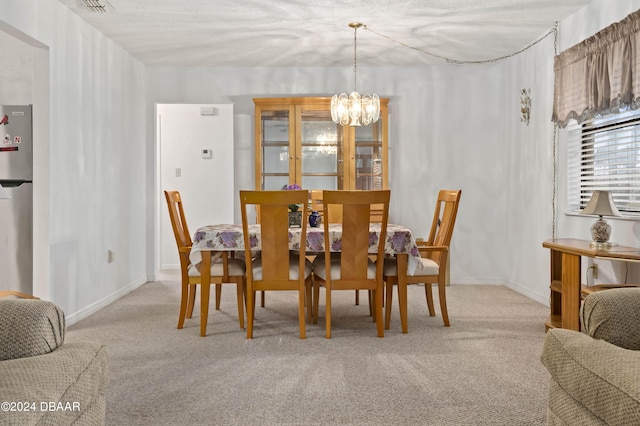 133 Cardinal Dr, Ormond Beach, FL 32176 - dining room featuring a chandelier and carpet
