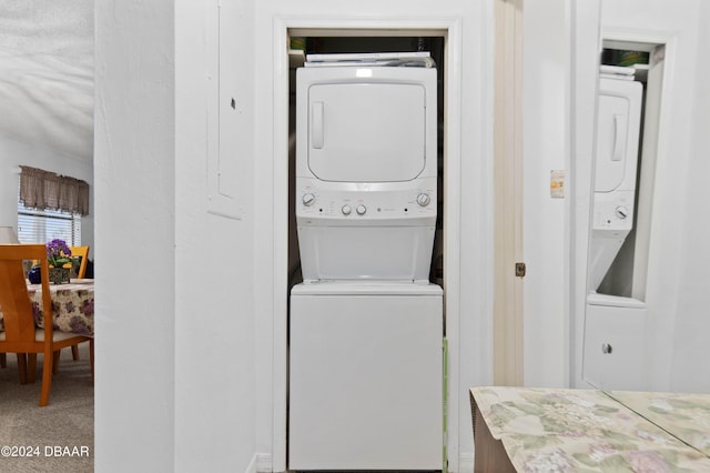 133 Cardinal Dr, Ormond Beach, FL 32176 - laundry room featuring stacked washer and clothes dryer
