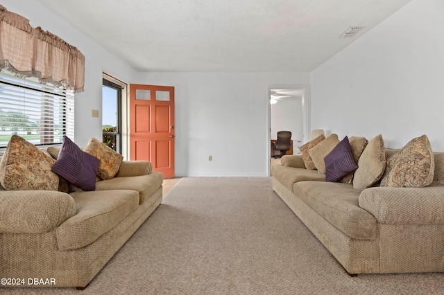 carpeted living room featuring ceiling fan