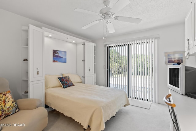 bedroom featuring carpet flooring, access to exterior, a textured ceiling, and ceiling fan