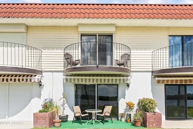 back of house with a balcony