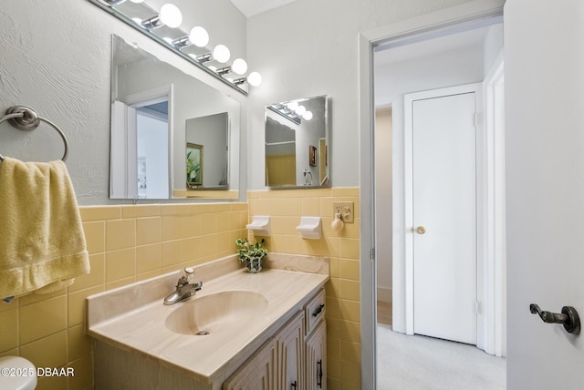 bathroom featuring vanity and tile walls