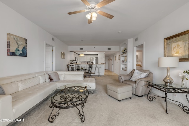 living room with light carpet and ceiling fan