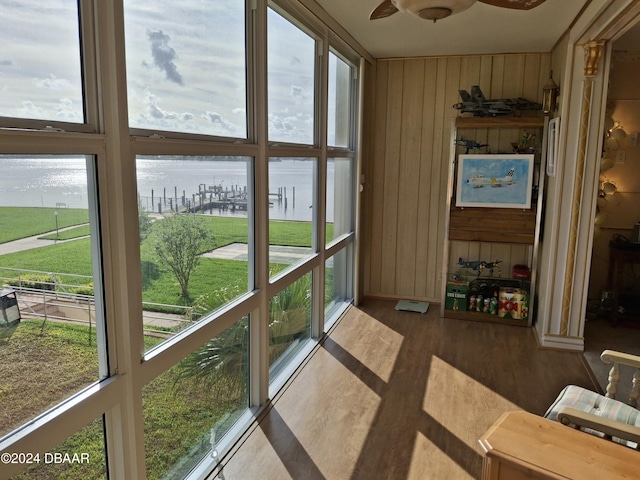 sunroom / solarium with a healthy amount of sunlight and a water view