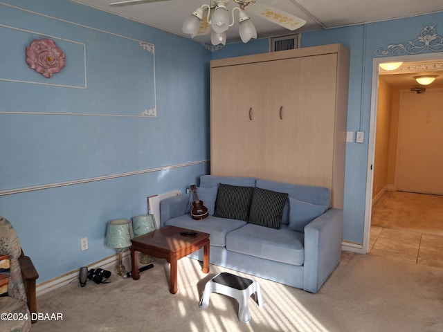 carpeted living room featuring ceiling fan