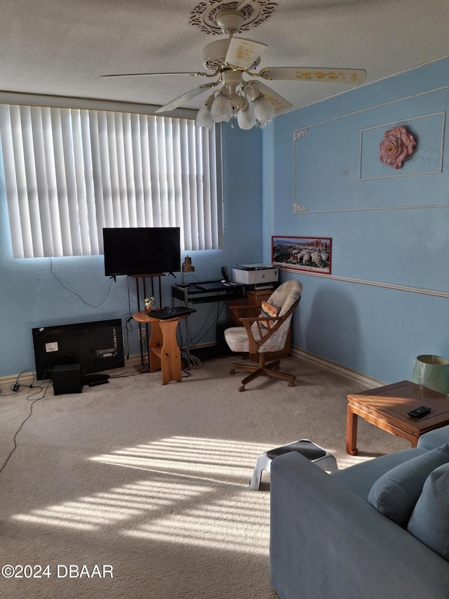 interior space with ceiling fan, a textured ceiling, and carpet flooring