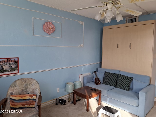 carpeted living room featuring ceiling fan