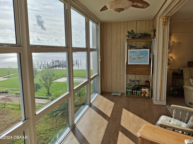 sunroom with a healthy amount of sunlight and a water view