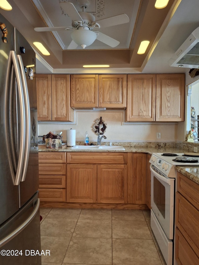 kitchen with white range with electric stovetop, sink, stainless steel refrigerator, and a raised ceiling