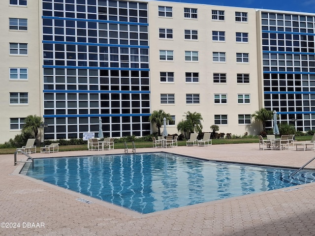 view of swimming pool with a patio