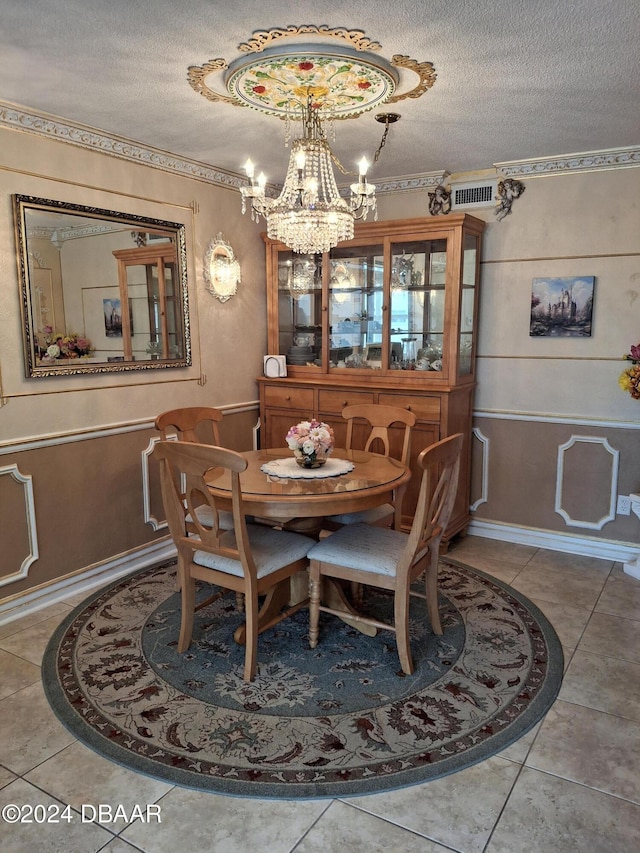 dining space with a textured ceiling and tile patterned floors