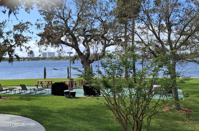 exterior space with a water view and a lawn