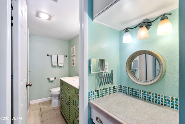 bathroom featuring toilet, vanity, and tile patterned floors