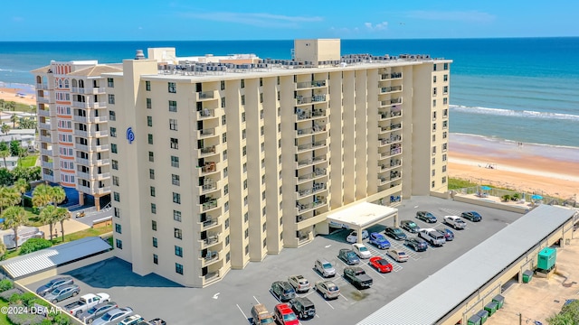 view of building exterior with a view of the beach and a water view