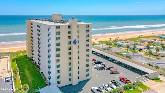 birds eye view of property featuring a view of the beach and a water view