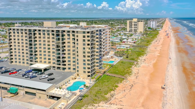 birds eye view of property featuring a view of the beach and a water view