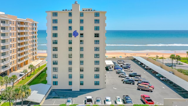 view of building exterior featuring a view of the beach and a water view