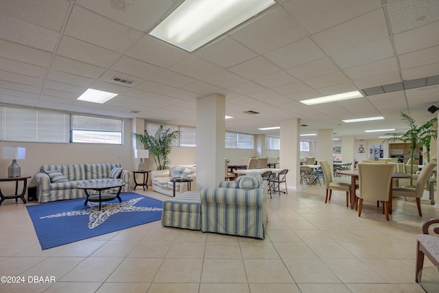 tiled living room featuring a paneled ceiling