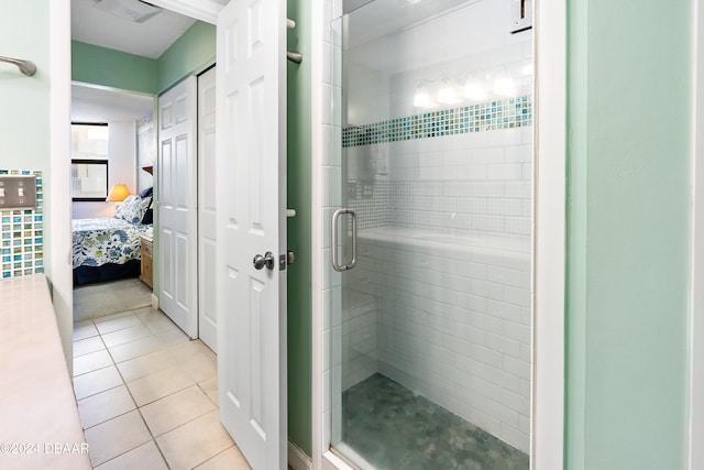 bathroom with tile patterned floors and an enclosed shower