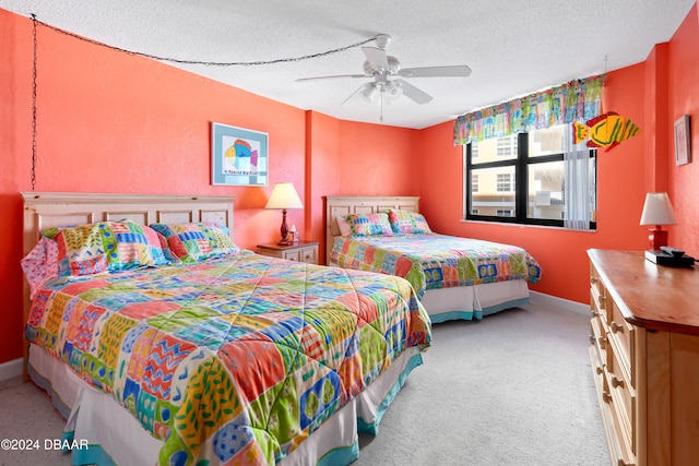 bedroom featuring ceiling fan, a textured ceiling, and light colored carpet