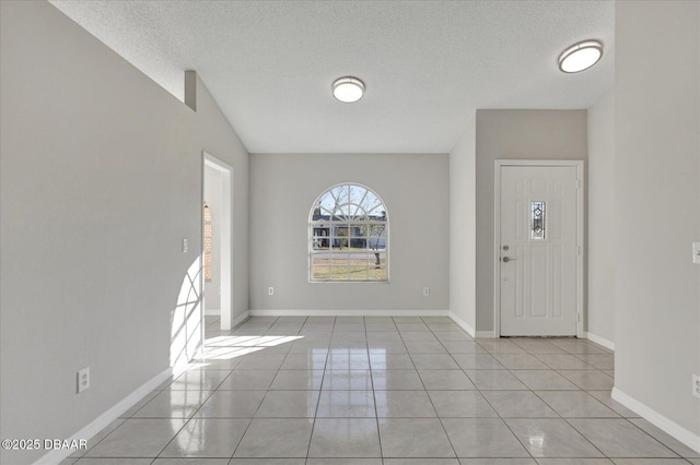 tiled entryway featuring a textured ceiling