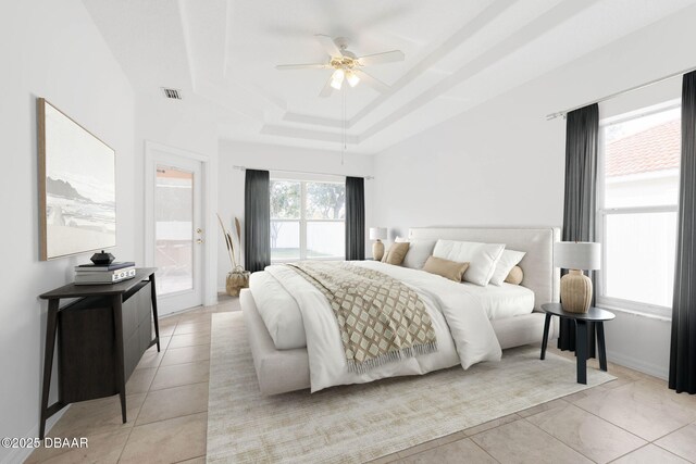 bedroom with a raised ceiling, access to outside, and a ceiling fan