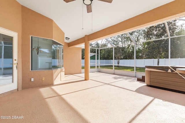 unfurnished sunroom featuring ceiling fan, lofted ceiling, and a hot tub
