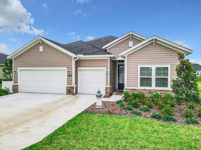 view of front of house with a front lawn and a garage