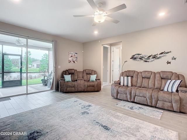 living room featuring ceiling fan and light hardwood / wood-style flooring