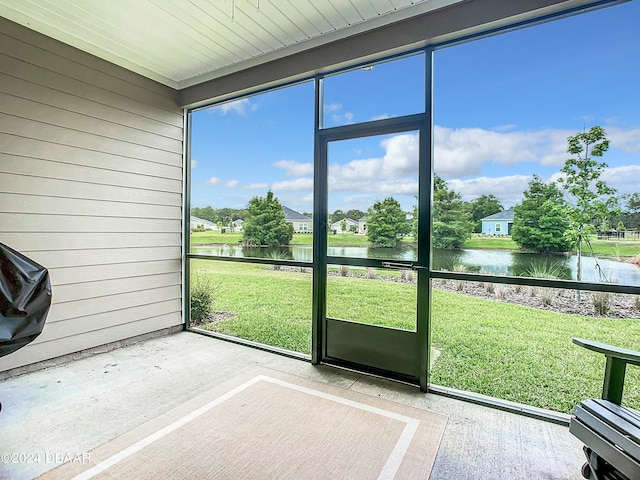 unfurnished sunroom with a water view