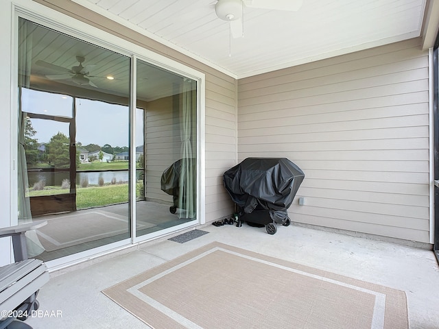 unfurnished sunroom with a water view and ceiling fan