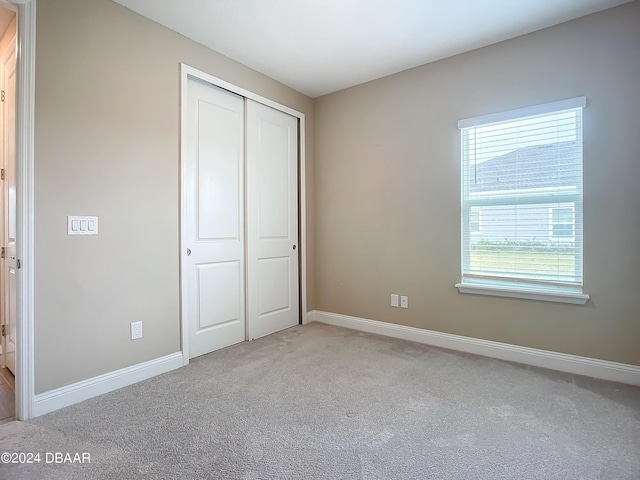 4155 Clifden Dr, Ormond Beach, FL 32174 - unfurnished bedroom with light carpet and a closet