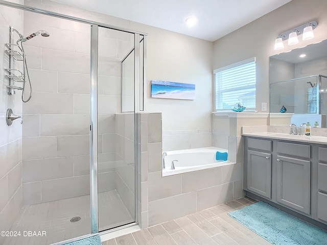 bathroom with vanity and separate shower and tub