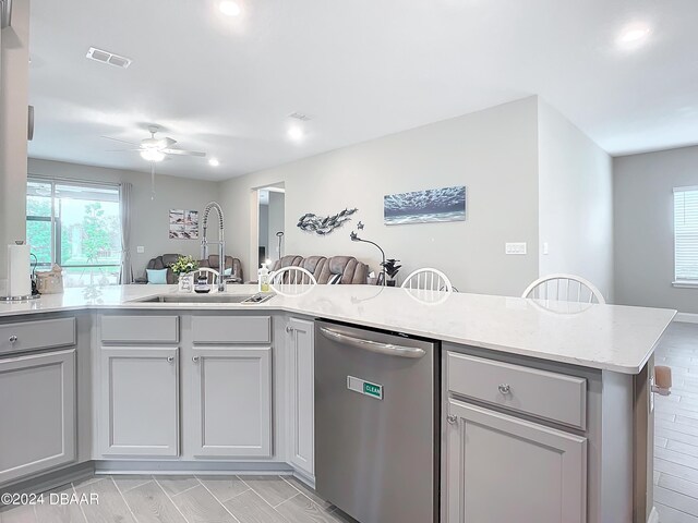 4155 Clifden Dr, Ormond Beach, FL 32174 - kitchen featuring kitchen peninsula, sink, light wood-type flooring, and dishwasher