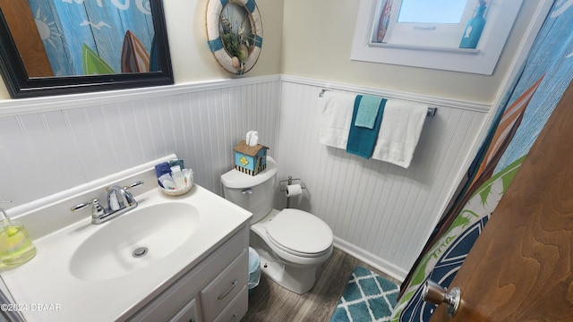 bathroom featuring toilet, wood-type flooring, and vanity